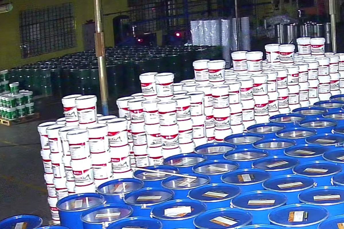 White and yellow grease pails lined up for filling