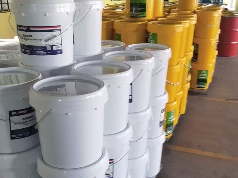 White and yellow grease pails lined up for filling